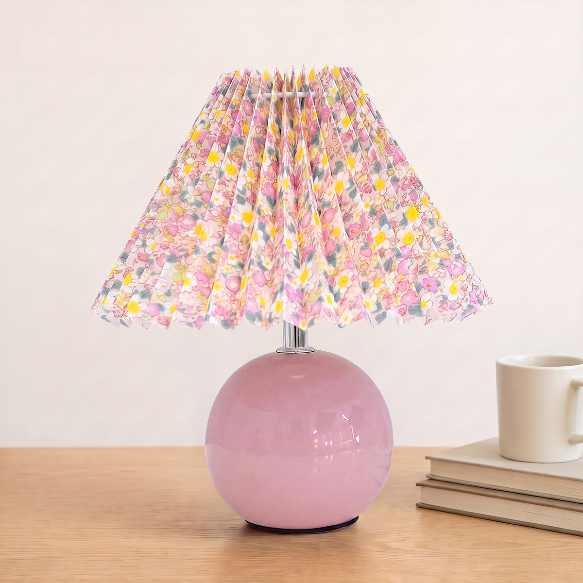 Nordic Ceramic Table Lamp, pink base, beside books and a mug to show its size